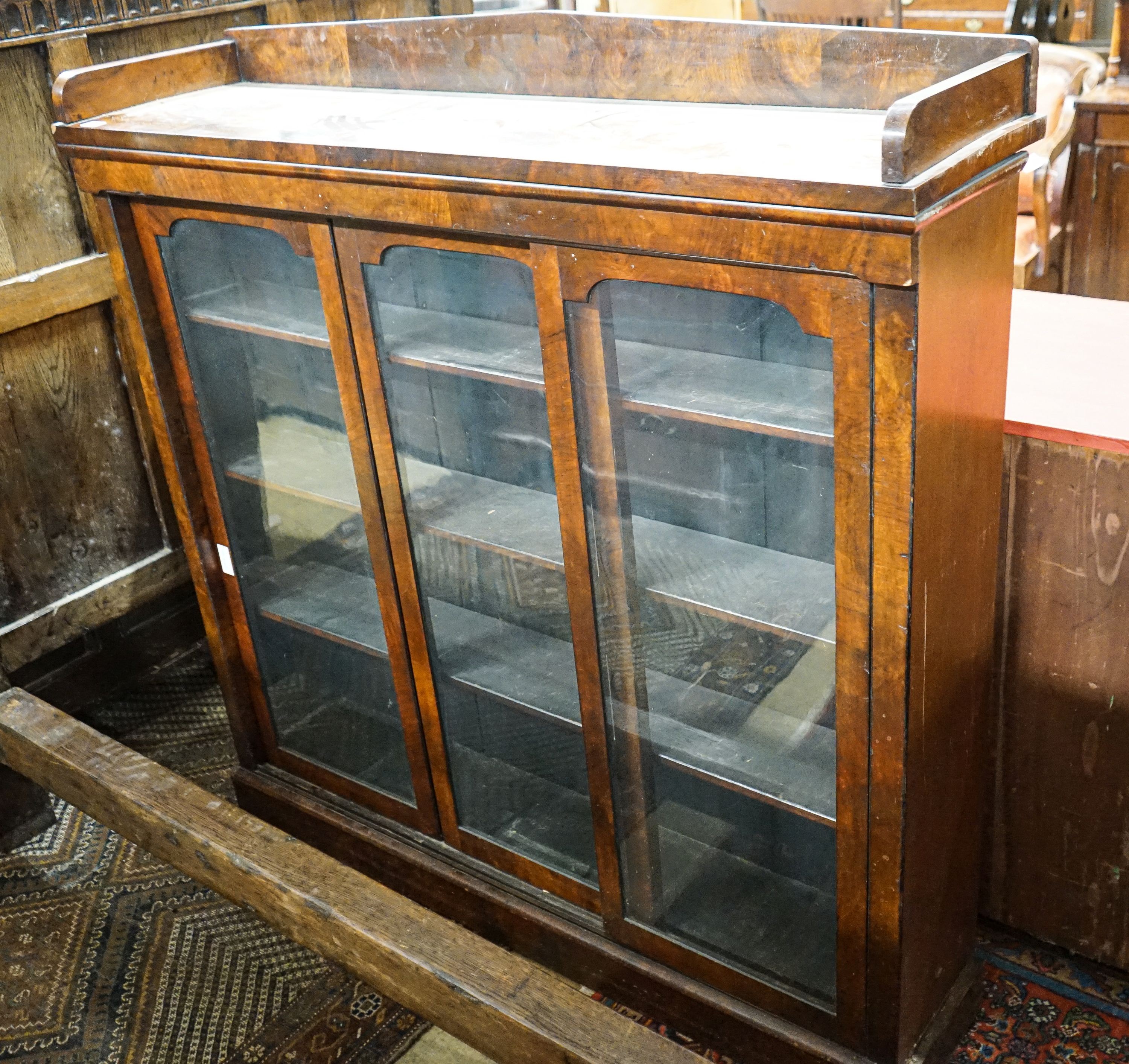 A Victorian mahogany sliding door glazed bookcase, length 130cm, depth 33cm, height 134cm